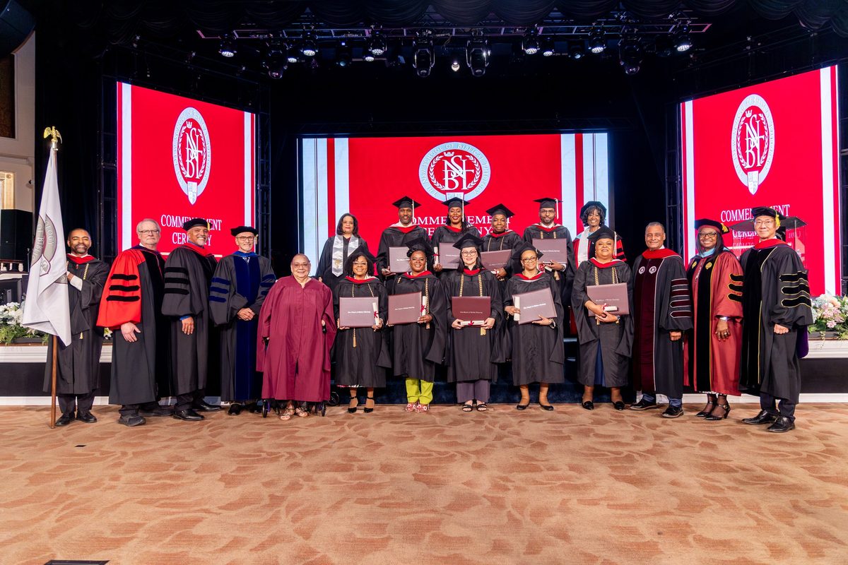 NSBT graduates and faculty on the stage at commencement, the Class of 2025.
